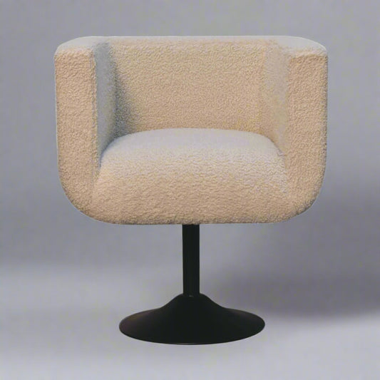 A cream boucle upholstered swivel chair with a black base.
